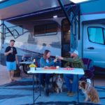 A family eats outside of an RV that should be insured by The David Nelson Agency